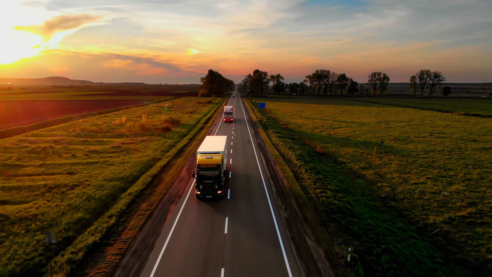 Amazing Aerial Drone View: Semi Trucks Delivering Goods by Road.